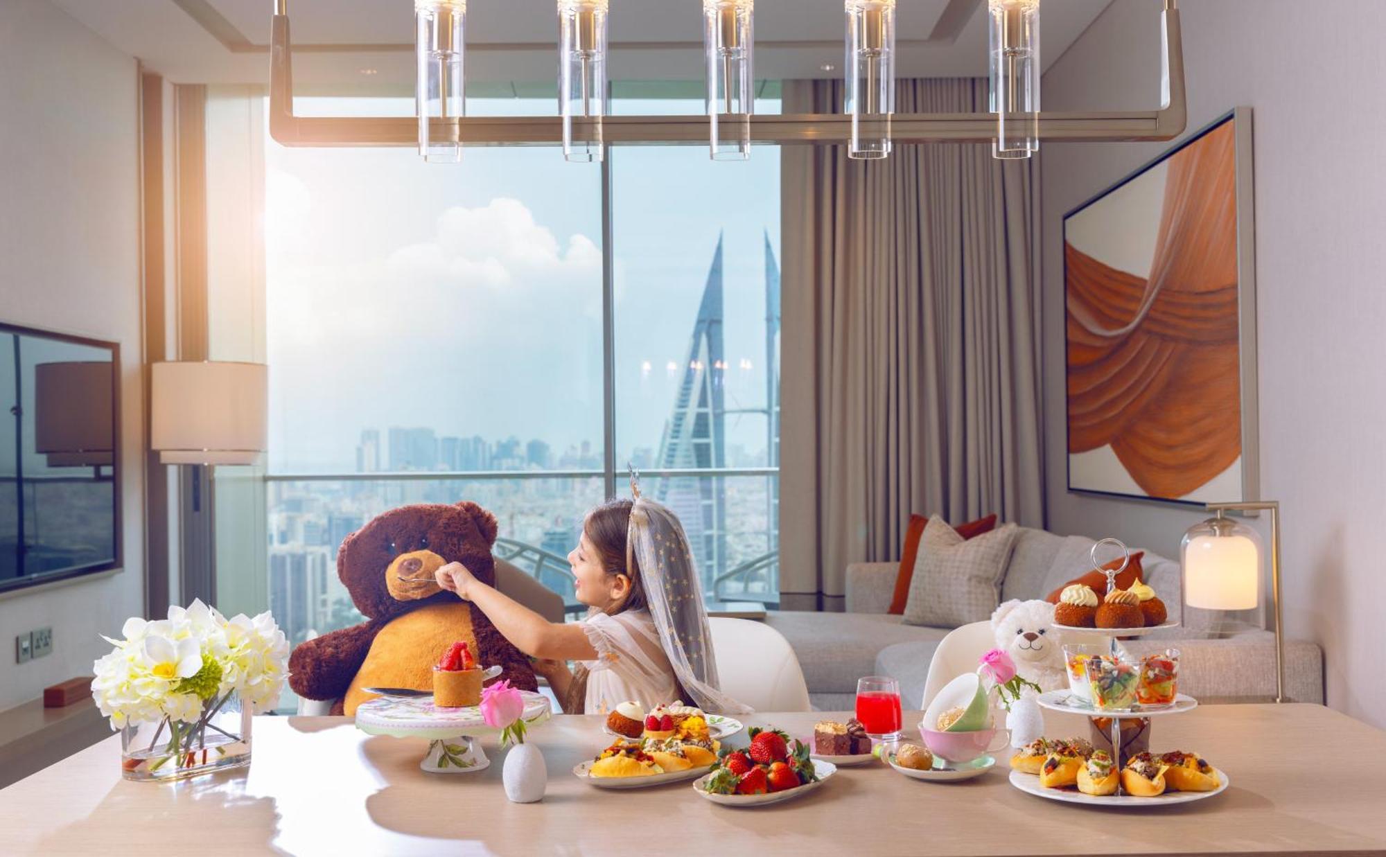 Onyx Rotana Hotel Manama Exterior photo A woman with a teddy bear